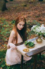 kobieta w lesie siedząca przy stole