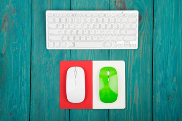 Wireless slim white keyboard, green and white mouses, notepad 