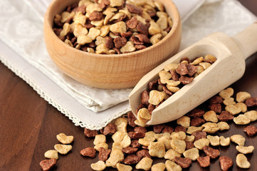 Assorti breakfast cereals in wooden bowl on wooden background