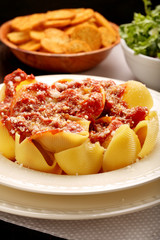 Lumaconi pasta with tomato sauce, bruschetta and salad