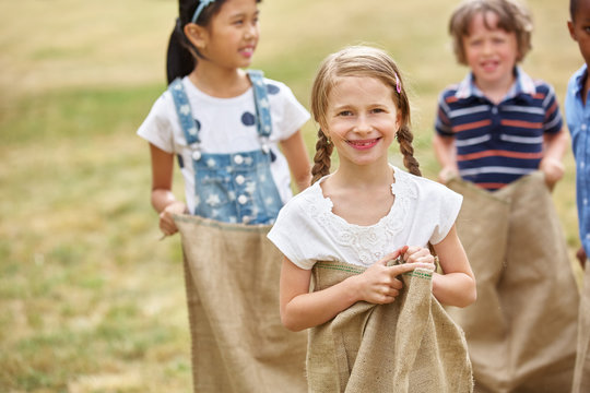 Kids competing at sack race