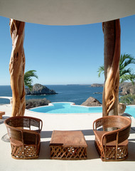 Furniture on the background of the sea and pool