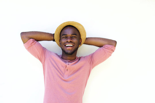 Young african guy laughing with hands behind head