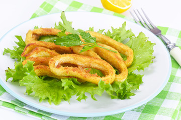 Fried Squid Rings in Breadcrumbs with Lettuce and Lemon
