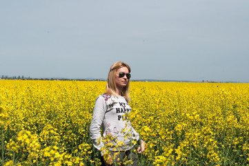 Woman and the colza field