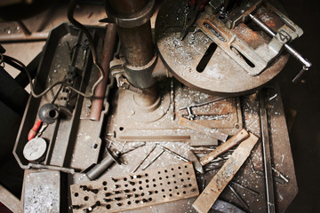 The wizard removes the excess weld using a power saw with a metal layout of a construction crane