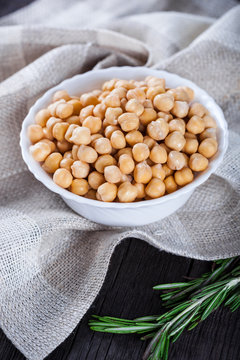 Chickpeas in bowl with rosemary, top view