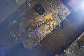 The wizard removes the excess weld using a power saw with a metal layout of a construction crane