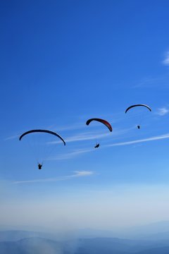Three paragliders in a row 