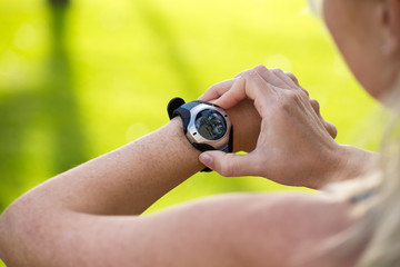 Female athlete tracking her activities using heart rate monitor