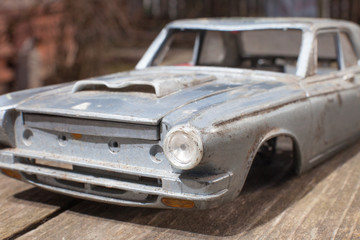 Obraz na płótnie Canvas Broken model of american car on wood table. small depth of focus. selective focus.
