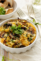 Casserole with fusilli pasta, mushrooms, cheese and herbs