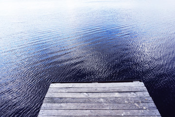 Wooden bridge pier of the boards on the river Mukhavets in Brest, Belarus.