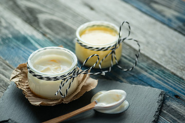 Jar with fresh yogurt on a rustic table
