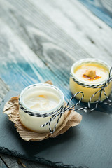 Jar with fresh yogurt on a rustic table