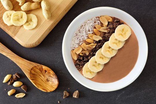 Chocolate peanut-butter banana, smoothie bowl downward scene on a slate background