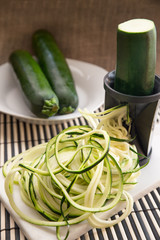 Healthy spiral zucchini being prepared for zucchini spaghetti 