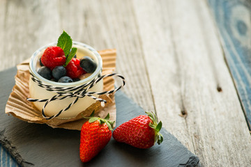 Jar with fresh yogurt on a rustic table