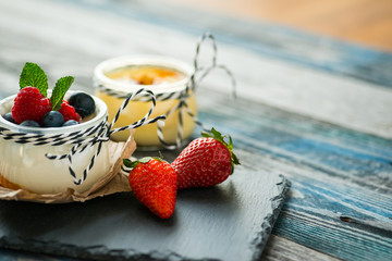 Jar with fresh yogurt on a rustic table