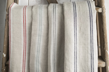 Four Folded Striped Cotton Linen Hanging on a Stepladder