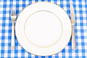 White Plate on a Checkered Tablecloth with Place for Your Text