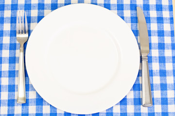 White Plate on a Checkered Tablecloth with Place for Your Text