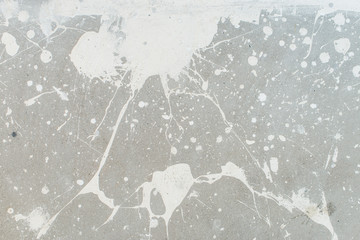 White splash on gray background concrete wall, messy, splotchy, surface. Decorative wet paint drops, abstract art.