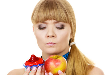Woman choosing fruit or cake make dietary choice