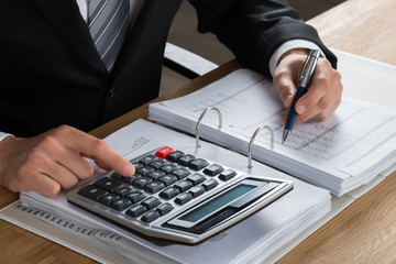 Male Accountant Calculating Tax