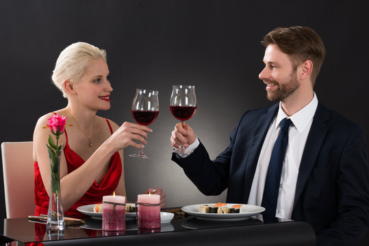 Young Couple Toasting Wine In A Restaurant
