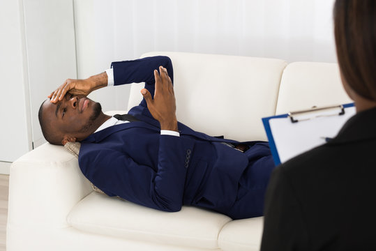 Patient Laying On Couch In Front Of Psychiatrist