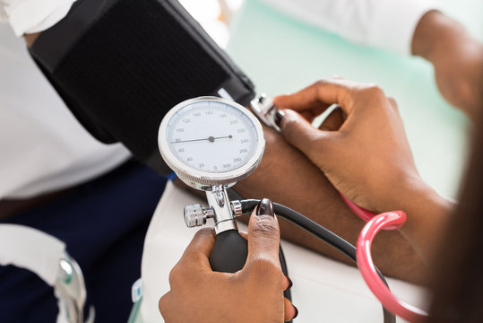 Doctor Measuring Patients Blood Pressure