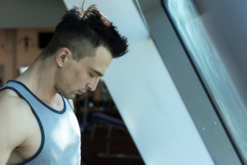 Little break. Handsome young men in sportswear at gym