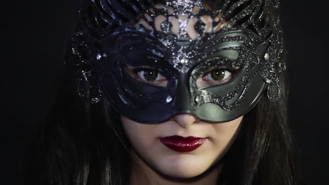 Beautiful girl in a mask with red lips