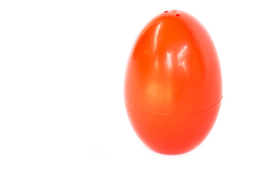 Red plastic egg on white background