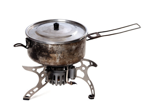 Camping gas stove and old sooty hiking pan