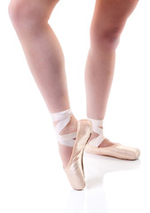 Focus on young ballerina's pointe foot.