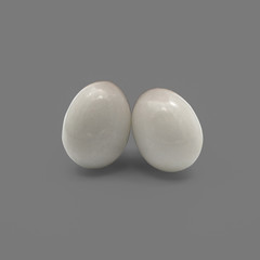White egg-shaped stone isolated on grey background