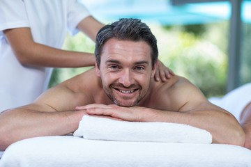 Fototapeta na wymiar Man receiving back massage from masseur