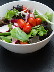 close up view of nice  vegetable salad  on black  back