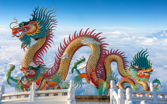 Colorful dragon statue with blue sky and clouds on heaven