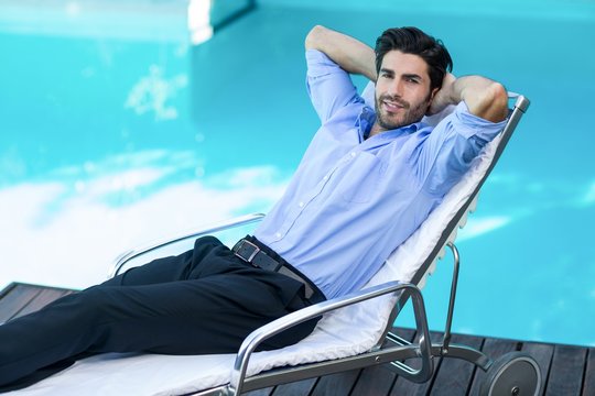 Smart man relaxing on sunlounger - Powered by Adobe