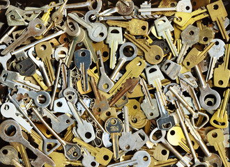 A lot of different yellow and white old metal keys background