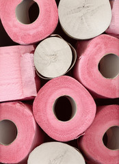 Pink toilet paper rolls closeup background