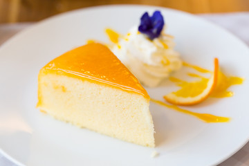 Orange cake on white plate. (Selected focus)