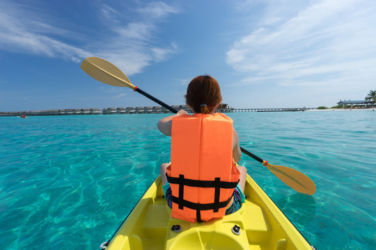 lady paddling the kayak in the sea, Maldives