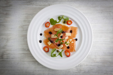 Salmon carpaccio on plate