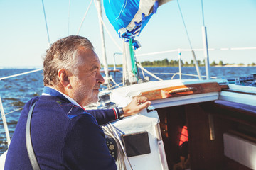 Fototapeta premium elderly man on yacht at sea