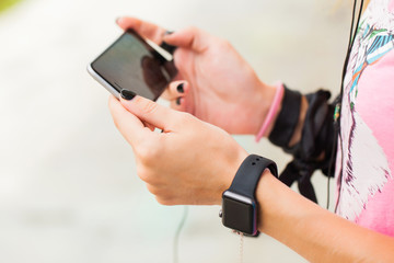 young girl posing in the street with smartwatch fitness tracker
