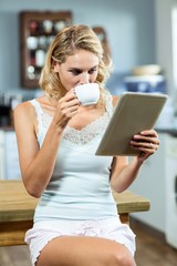 Young woman drinking coffee at home